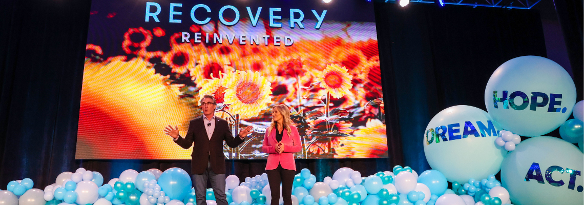 Governor and First Lady Burgum stand on stage at Recovery Reinvented
